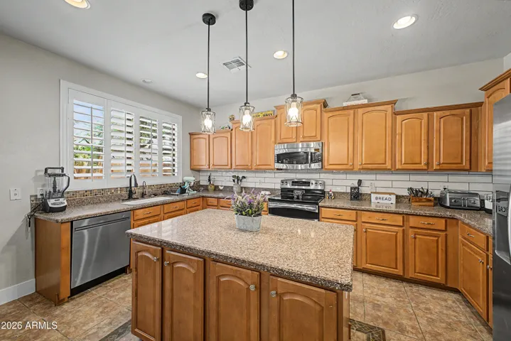 Staggered Kitchen Cabinets with Granite Countertops