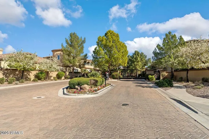 Secure gated community entrance with landscaped surroundings, providing privacy and curb appeal in this desirable Phoenix location.