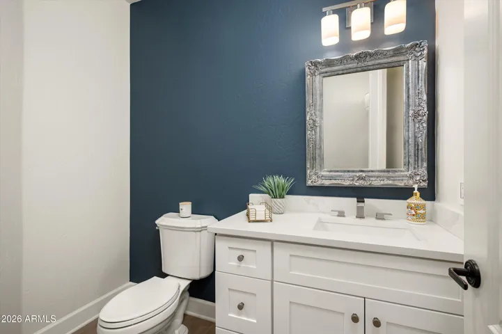 Stylish powder bath with updated vanity, modern fixtures, and designer finishes, adding a touch of elegance to this upgraded Phoenix home.