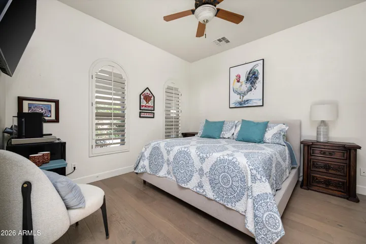 Comfortable casita bedroom ideal as a guest suite or home office, featuring natural light and flexible use within this thoughtfully designed Phoenix home.