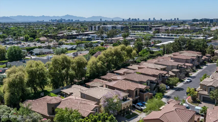 Aerial view of a well-maintained neighborhood with mature landscaping and nearby amenities in the heart of Phoenix.