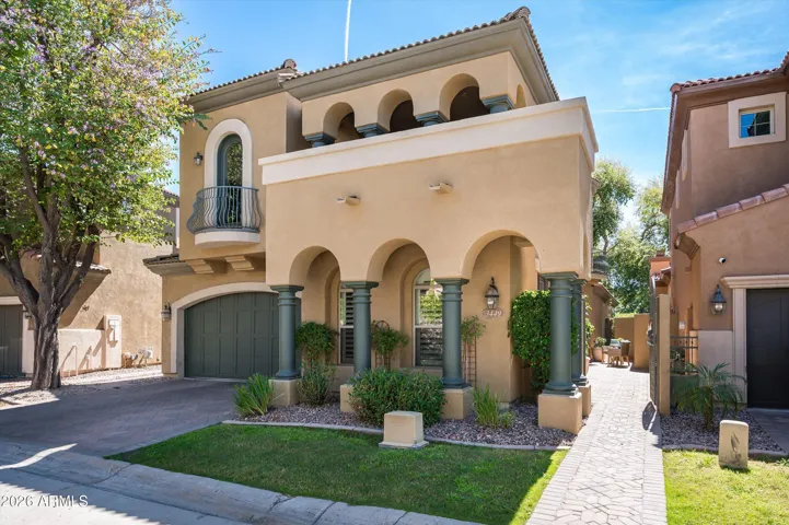 Beautiful exterior with stucco finish, private courtyard entry, and low-maintenance landscaping in a gated Phoenix community.