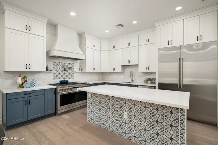 Renovated kitchen featuring premium Monogram appliances, custom cabinetry, and modern finishes—perfect for cooking enthusiasts seeking a high-end Phoenix home experience.