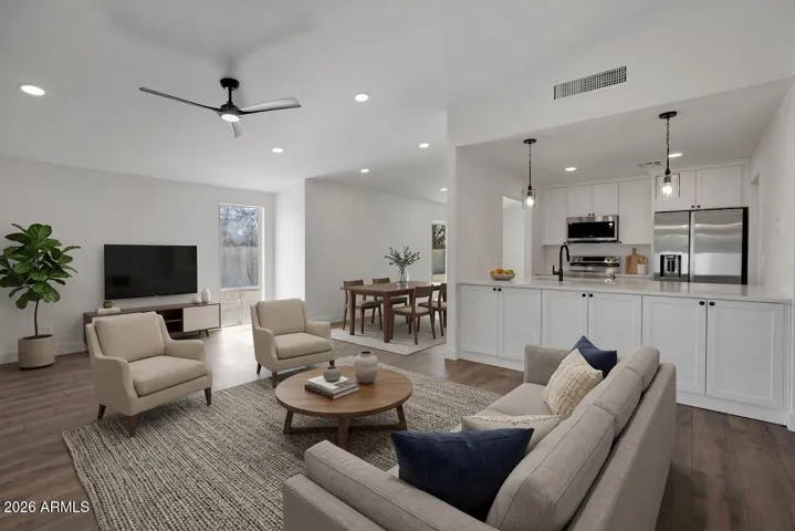 Virtual staging of great room view into kitchen and dining area