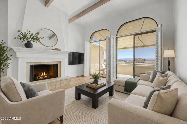 Virtually Staged living room with high ceilings leads out to the patio and city views.