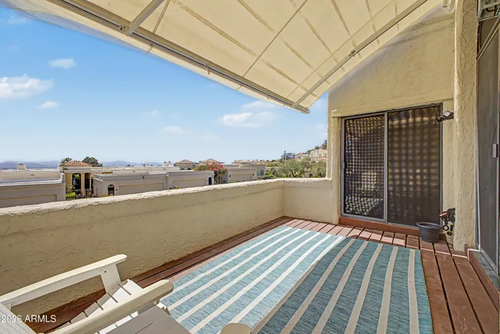 The spacious patio is accessed through sliders from the living room and the primary bedroom and boasts amazing views of Camelback Mountain and the city lights.
