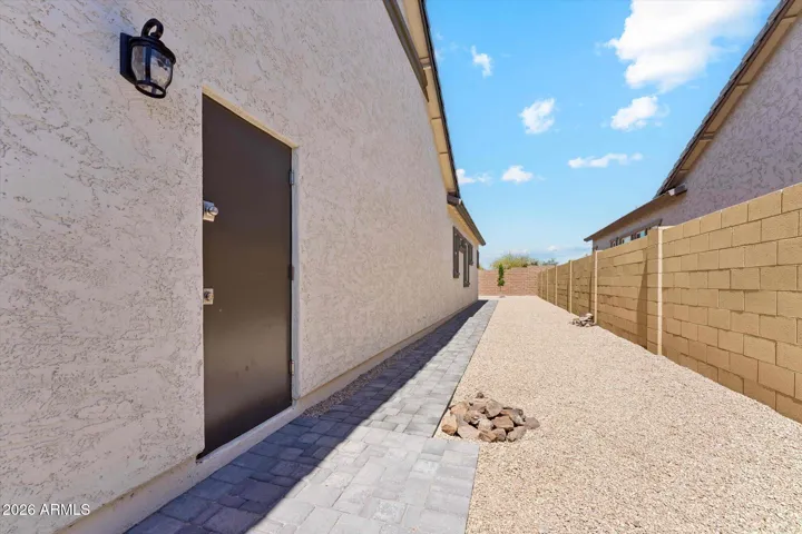 Wide side yard with Paver Walkway from rear to upgraded 5 foot front gate.