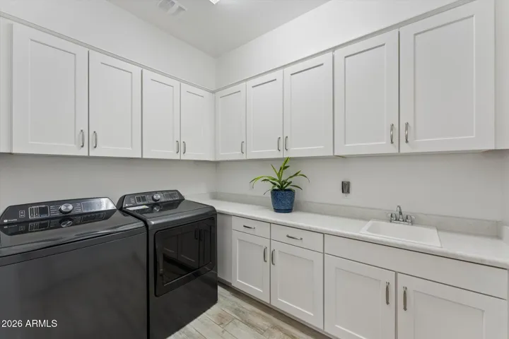 Large Laundry room with lots of storage and sink