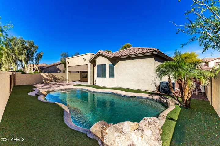 Backyard with turf, pavers and beautiful pool