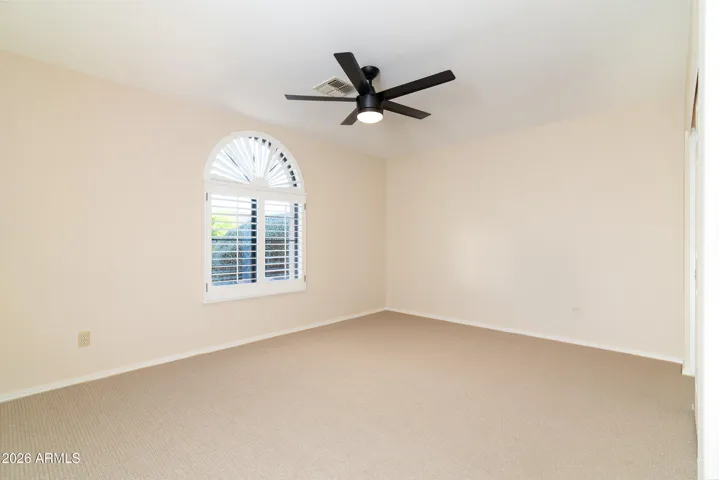 Guest bedroom with brand new carpet and fan with light