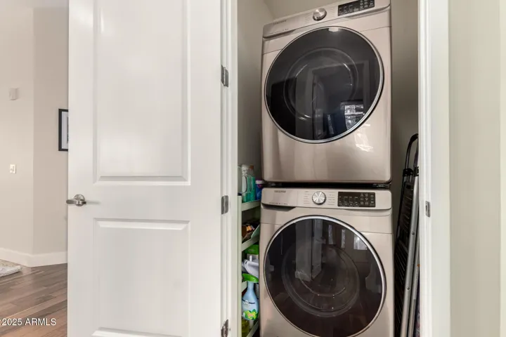 Stacked washer and dryer in unit.