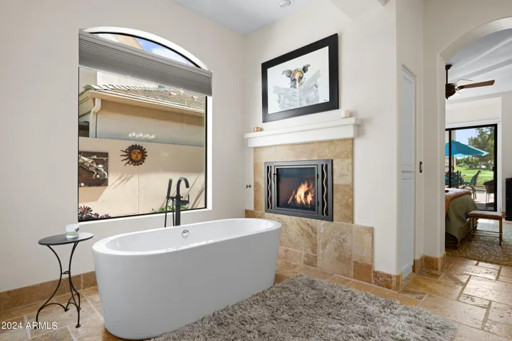 Free standing tub in front of the gas fireplaces.