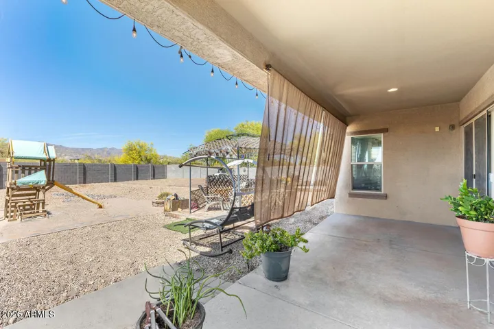 Backyard with Covered Patio and Shade Curtains