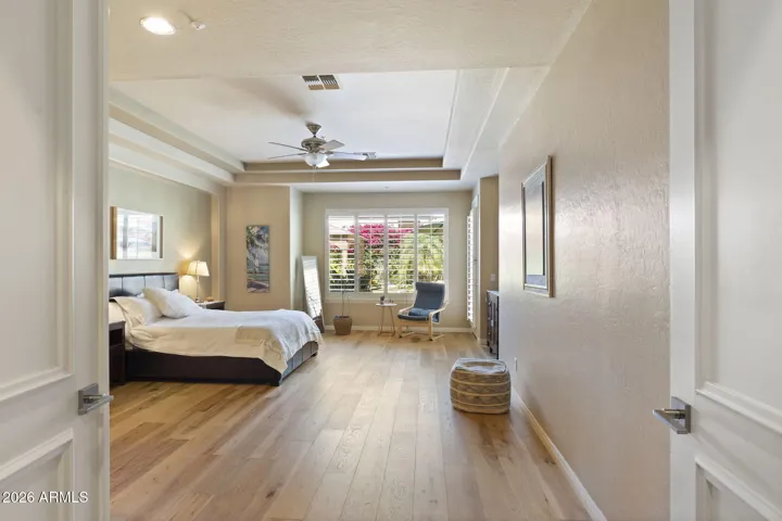 Primary bedroom with Hickory hard wood floors and plantation shutters
