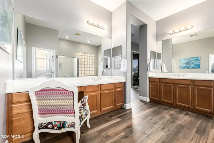 Expansive primary bath featuring split dual vanities with generous storage.