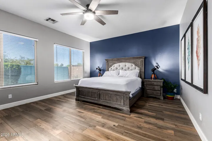 Spacious primary bedroom with ensuite and doors that open to the yard.