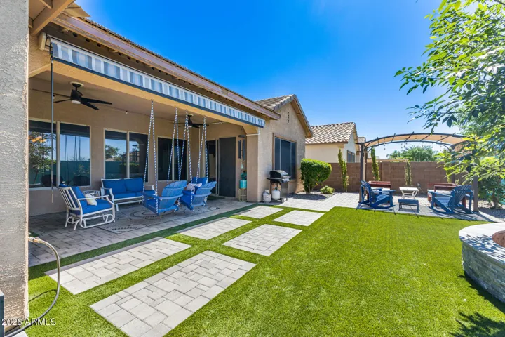 Spacious covered patio with awning for extra shade and pergola for even more shaded space.