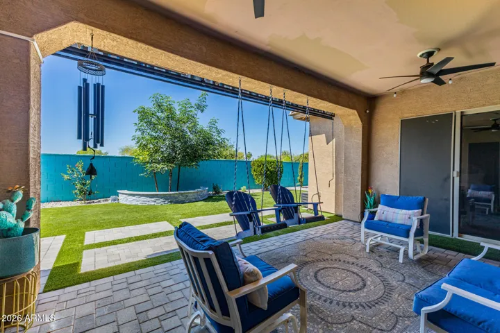 Spacious covered patio and relaxing backyard. Blue Patio swings do not convey