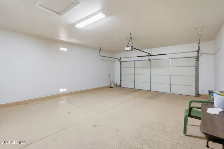 Extended two-car garage with newer garage door and opener.