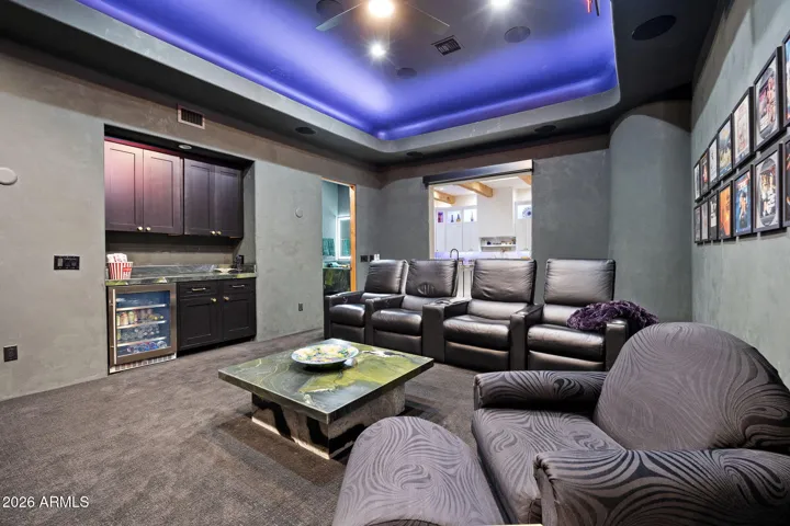 Theatre room with dry bar, beverage fridge and power room. Electronic black-out shade can be lowered to enhance the exprience.