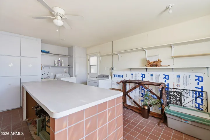 Laundry room with island is perfect for crafts, folding laundry.
