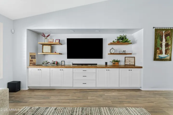 Sellers added floating shelves with back lighting, countertops, and cabinets