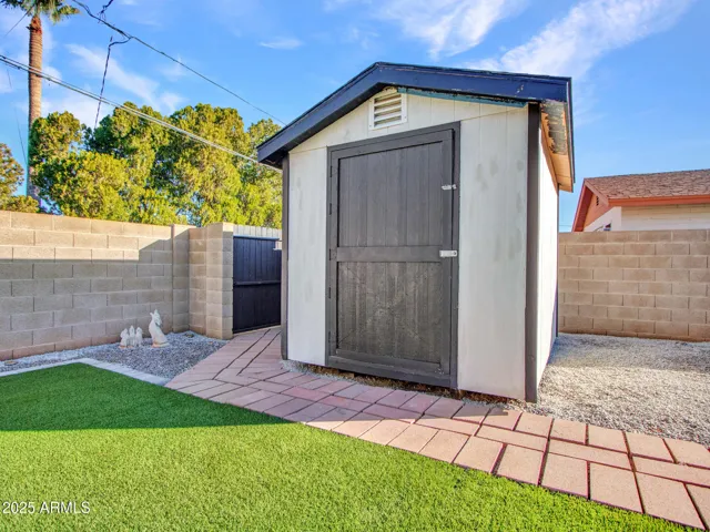 Large shed provides storage or could be converted to office or play house.