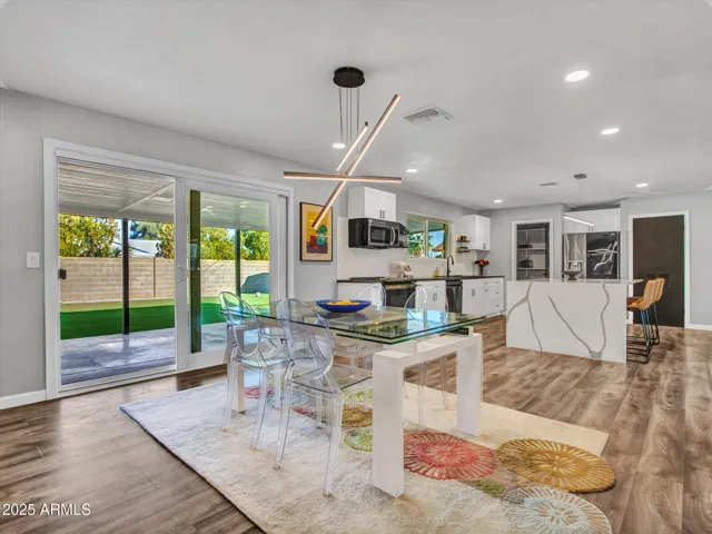 Dining off Kitchen with modern lighting for convenience.