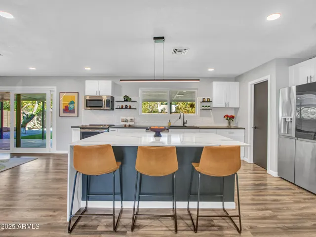 Large Quartz waterfall center island with seating & storage