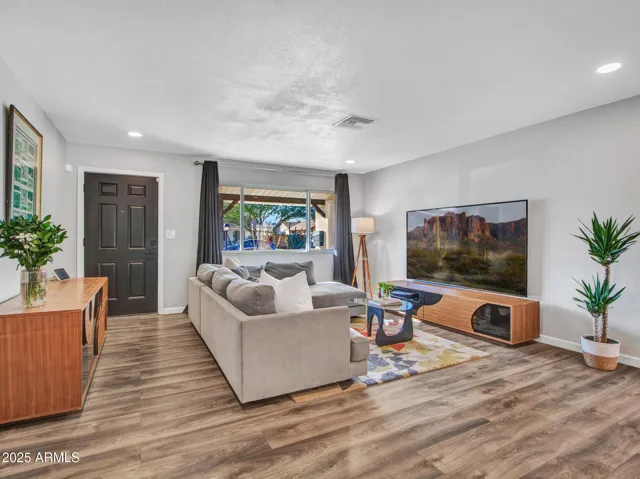 Natural lighting and Luxury Vinyl wood flooring create a cozy and inviting living room