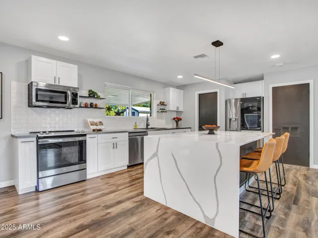 Gorgeous Quartz waterfall island w/seating, Stainless appliances and white shaker cabinetry (soft close).