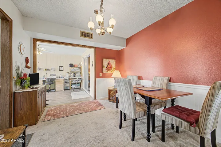 Dining area view to the wide open Family/Craft Room with a slight step down. Kitchen is to the left