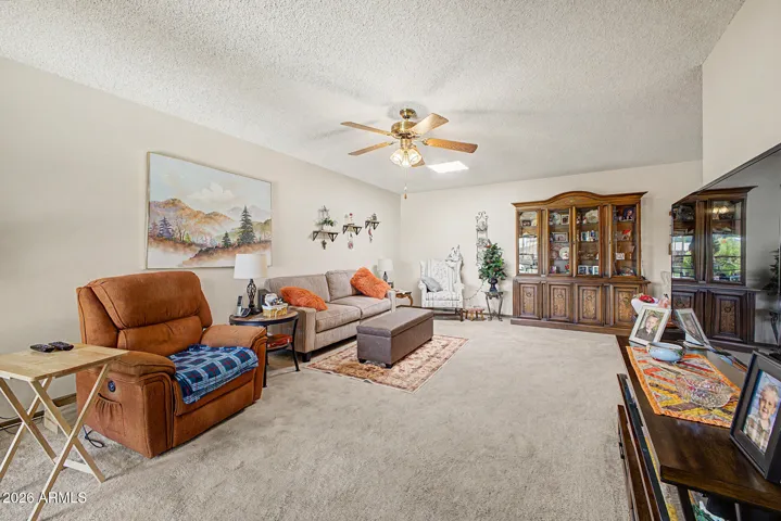 Large Living Room with a fan and skylight for extra light and air. Newer carpet in 2020