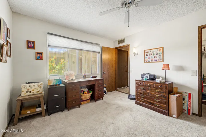 Bedroom 2 with newer carpet, fan & walk in closet