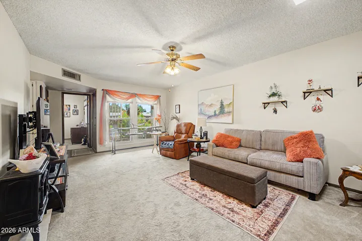 A view from the living room to the entry with a security screen door. The picture window is just one of the "newer" dual panes installed in 2022.
