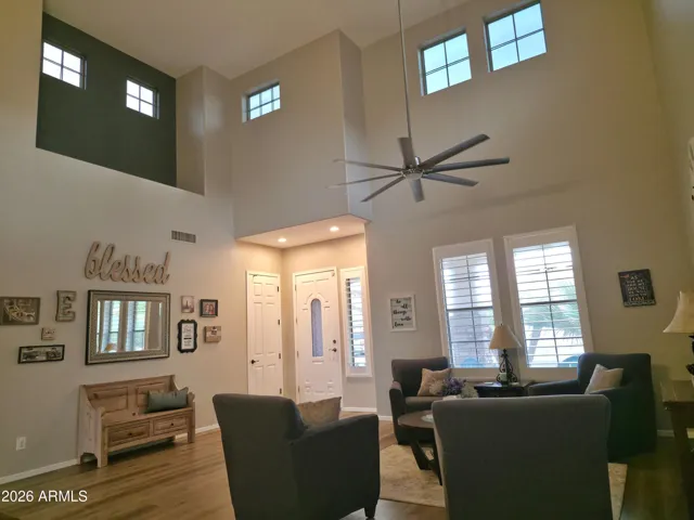Entry and living room with high ceilings and shutters
