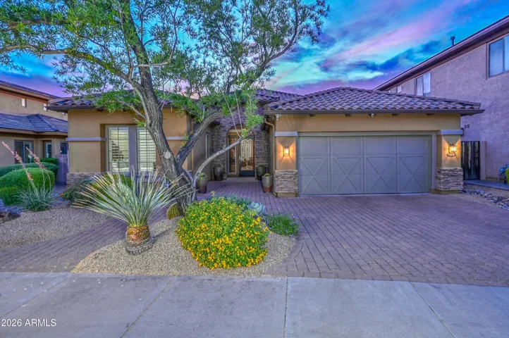 The mature landscaping and pavered driveway creates a stong first impression.