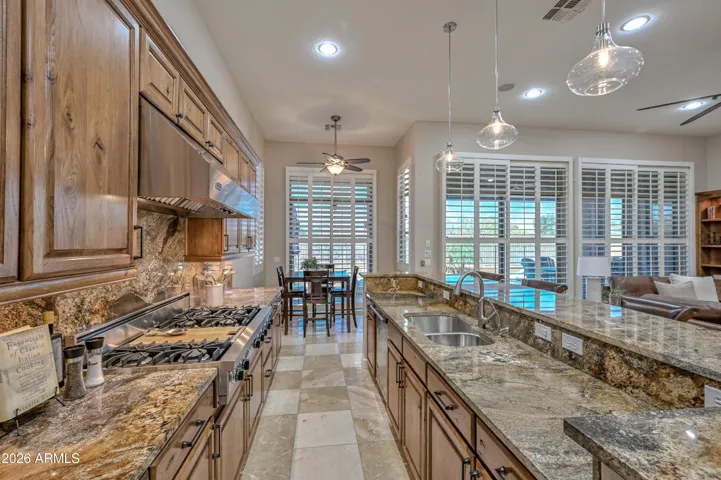 This kitchen really shines in every way. The highly desirable appliances, beautiful granite, 6 burner gas cook top with a griddle and so much more!