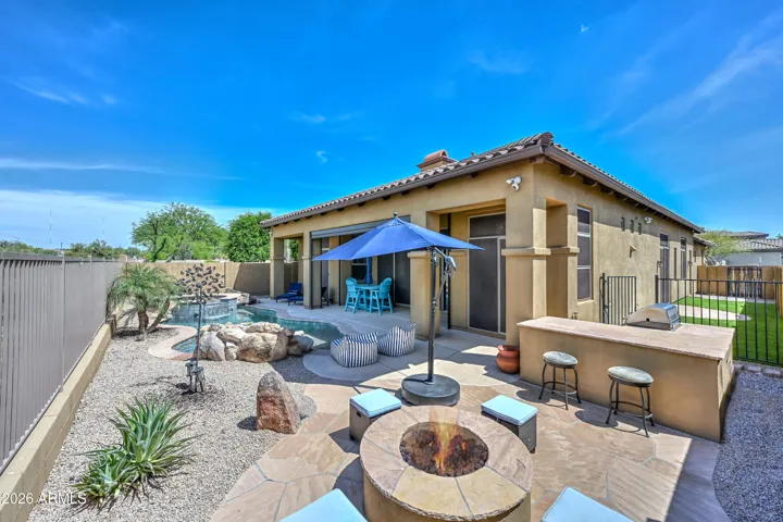 This 7420 sqft lot is what you dream of in Arizona! The stunning pool, spa, built in BBQ, gas fire pit and NEW artificial turf are just a few of the many thins you will love about this yard. The new turf is designed to be cooler than the ground.
