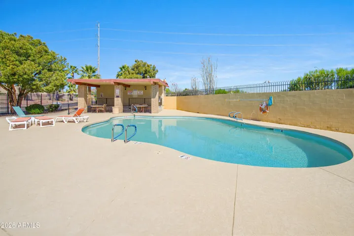 First of 2 community pools and grassy areas. Low hoa and walking distance to grocery stores and more