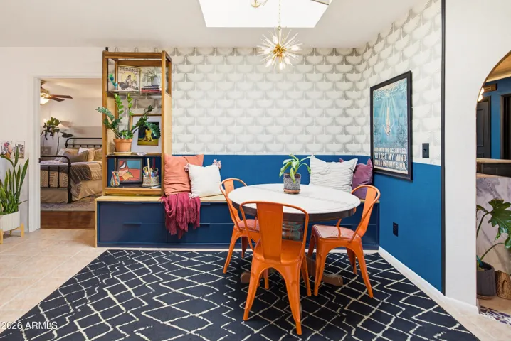 Open dining room adjacent to the kitchen. Zoom in on the fabulous mid century modern wallpaper and built in bench seating.
