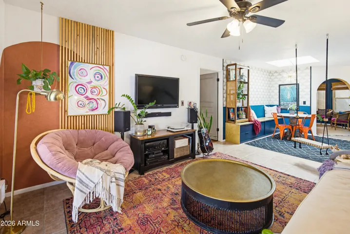 Walking in from the patio, open living and dining rooms. Note the custom painted wall with artisan wood slat feature.