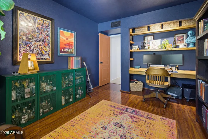 Bold, moody, on-point design and paint choices do not disappoint in this third bedroom / office.