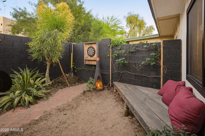 This area of back patio faces east. Block fence, garden, game area, seating