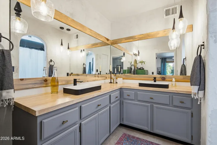 Remodeled primary bathroom with dual/ double vanities and updated fixtures