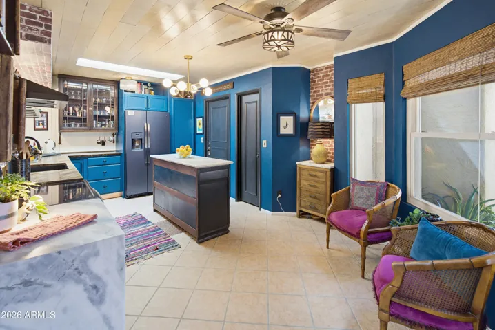 Remodeled kitchen has Dolomite, natural stone countertops, walk in pantry, charming custom built ins and whimsical details. Sitting or breakfast nook to the right.
