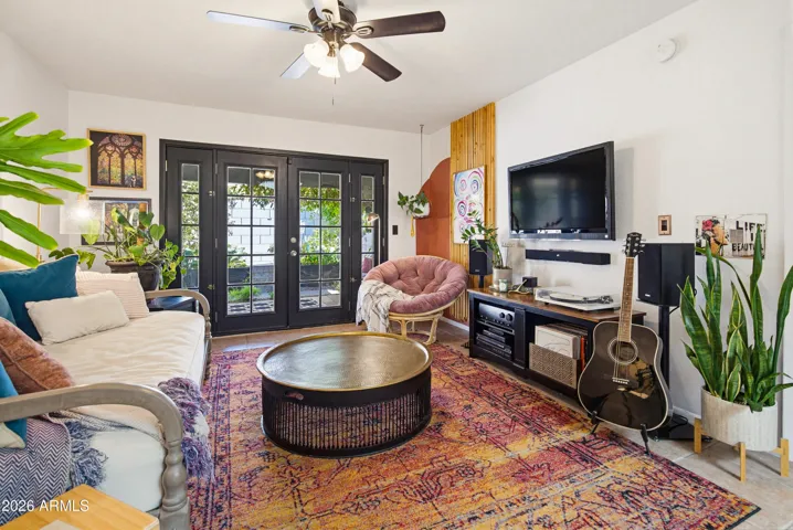 Glass French doors and large windows let in ample natural light and view of the backyard