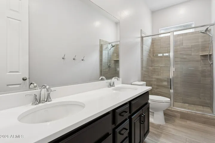 Bathroom 3 has dual vanity and step in shower