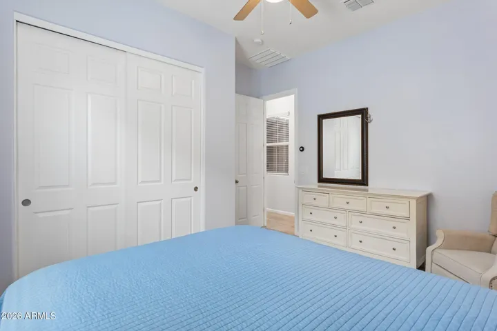 Secondary bedroom with fan and large closet
