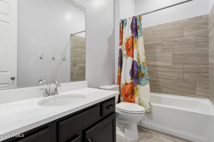 Full bath with tub and tile surround